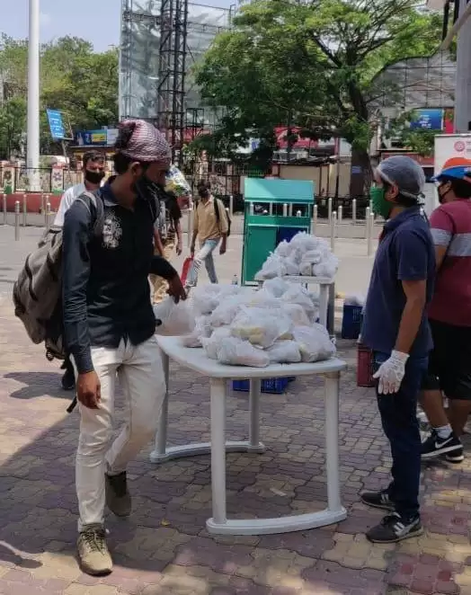 Passengers served with snack packets as they leave Pune on trains