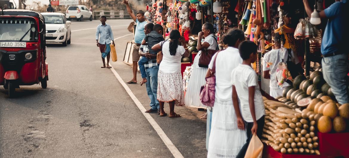 People shop at a market outside Sri Lanka's capital, Colombo.