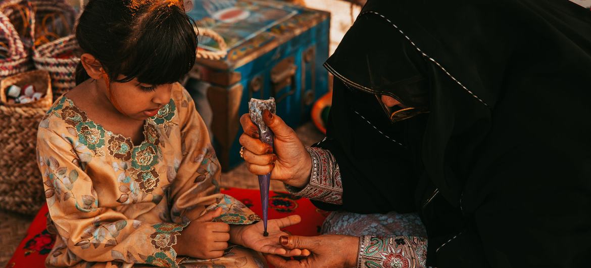 Applying henna in celebration of Eid, United Arab Emirates.